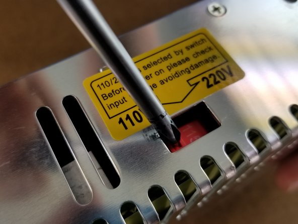 Using a screwdriver slide the switch so it displays 115 on the switch.