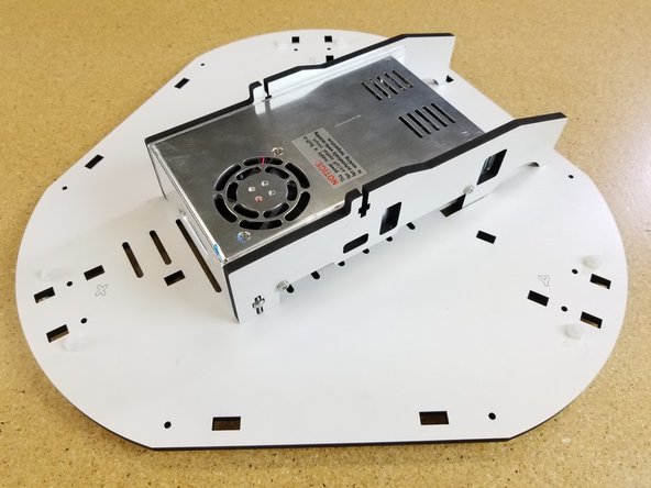 The PSU assembly installs into the base plate with (2) 6-32 x 1&quot; screws. These screws will go into the nylon lock nuts you installed in the previous step.