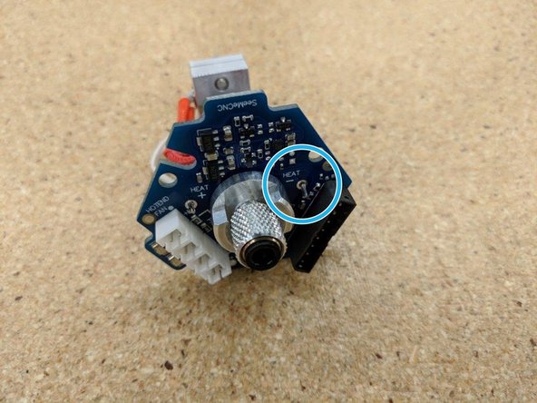 Insert the stripped lead into the location marked &quot;HEAT -&quot; as shown by the blue circle.