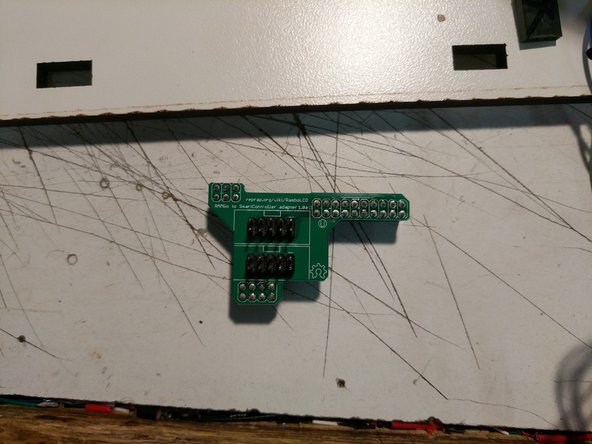 Locate and install the LCD adapter onto the RAMBo board in the position indicated. Ensure that you properly align the pins and headers of both components.