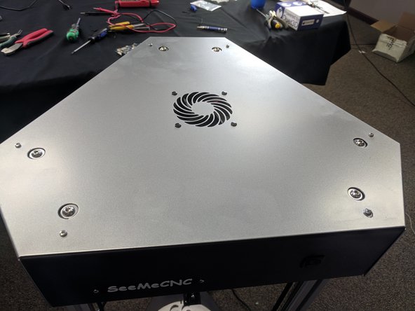 After you have plugged in the fan, slide the cover down onto the top of the printer and secure with the 6 removable plastic rivets or tighten the 6 screws. Remember, NO POWER TOOLS!