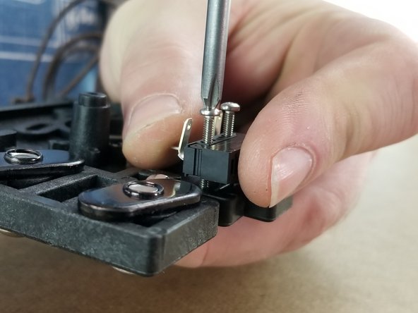 Tighten the endstop to the bracket. The screws will thread directly into the plastic bracket.   Be careful not to strip the screw head and take your time tightening the screws to secure the endstop.