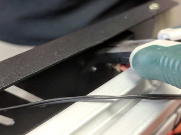 These nuts are hard to get to. It is easiest to hold them with a pair of needle nose pliers, and even better if you have angled needle-nose pliers.