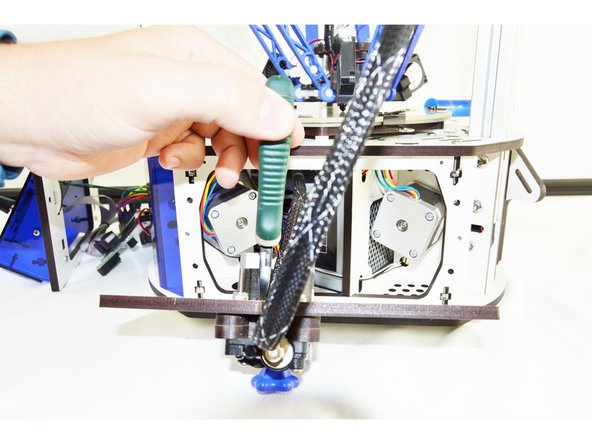 Cut the cable tie securing the existing wiring whip to the side panel.