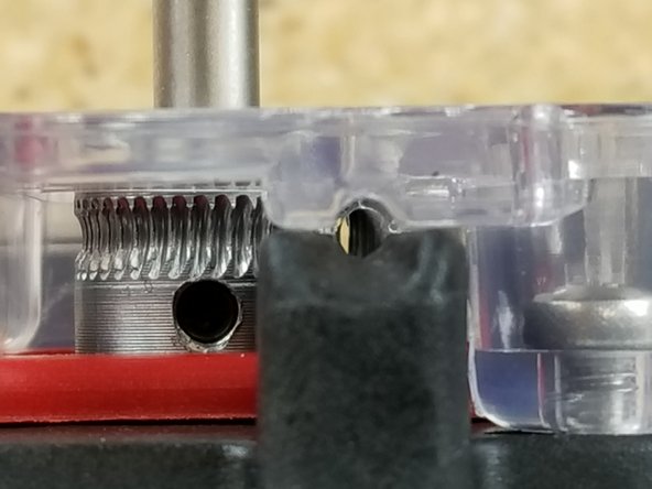 Slide the hobbed drive roller on the motor shaft. Align the  curve of the gear teeth with the bearing in the EZR and tighten the set screw.