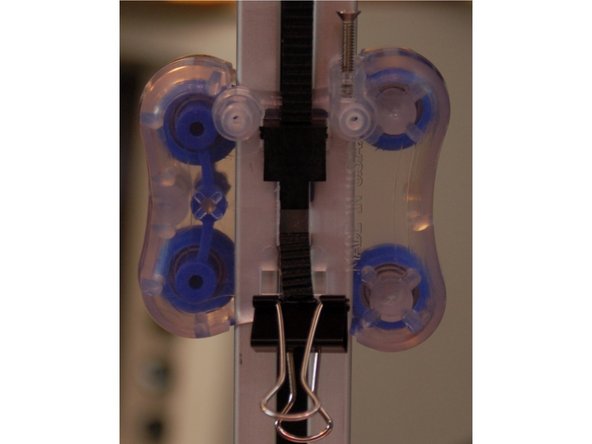 Pull the bottom belt tight and install the second clip.  If you're careful, you won't need to adjust the belt tension when you're done.