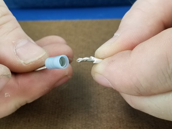 Place the blue ring terminal over the pair of wires and crimp as before securing the two wires in the blue ring terminal.