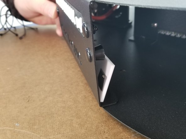 Line the white acrylic up behind the logo and press the double sided tape into the sheet metal to secure it in place.