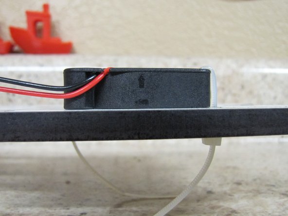 You will be mounting the 40mm fan to the top of the Motor Plate using 2 zip ties, one on the upper left and one on the lower right corners of the fan.