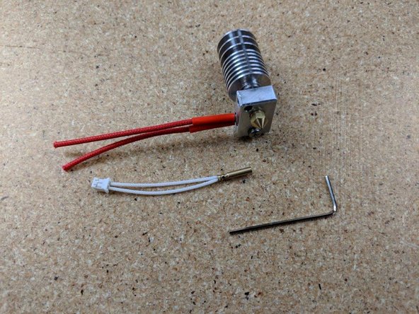 Tighten the screw to secure the heater cartridge in place. You can use pliers to hold the block in place while tightening the screw.