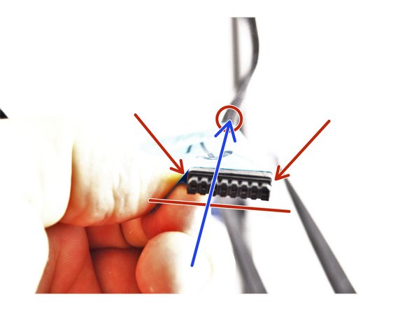 You want to insert the bowden tube into the mesh loom on the same side of the connector that has the beveled edges. This is noted in the picture with red makers.