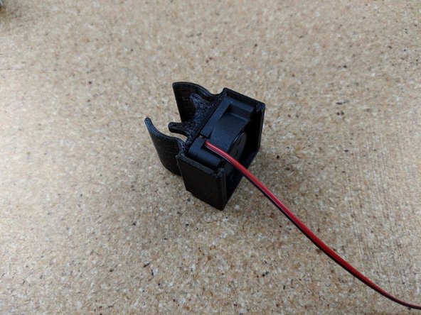 Insert the fan into the fan shroud as shown in Pic 2.  The label on the fan should face the curved parts of the fan shroud and the wires should be at the top as shown.