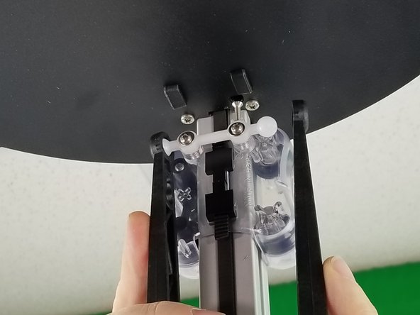 Start by snapping the arms on the carriages.