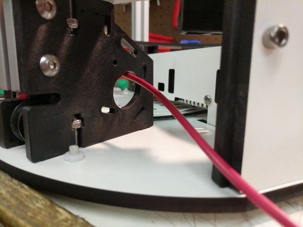 Insert the extrusion into the base top plate, and then through each set of the TSLOT hardware. You will need to have the TSLOT nuts in a vertical orientation to be accepted by the extrusion. You also may need to loosen the TSLOT nuts if you have them too tight.