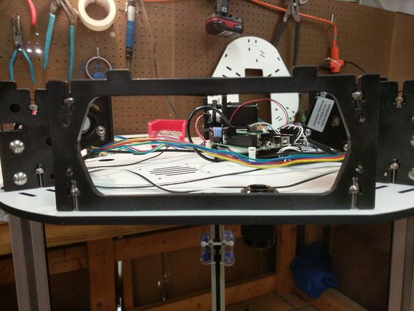 Insert 6-32 nylon lock nuts into the nut traps on the injection molded base sides.