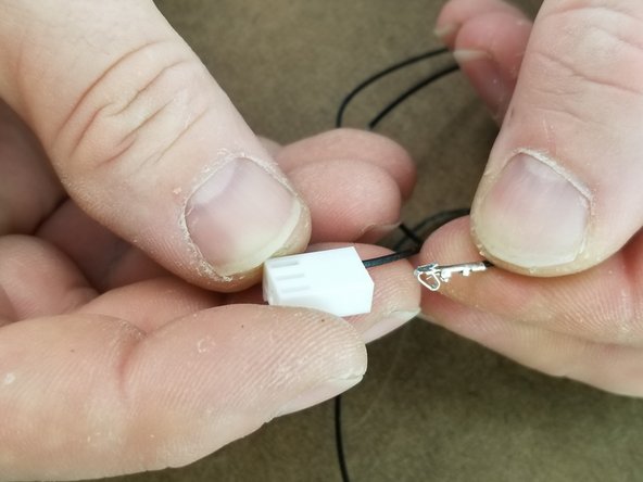 Insert the crimped end of 2 wires into a white connector as shown in Pic 2.  The crimp will push fully into the connector until you hear a click to lock it in.