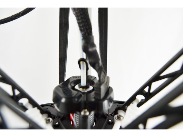 Press the red release trigger and push filament down through the filament path on the side of the EZR Struder until you see it in the clear PTFE tube (connected to the EZR Struder)