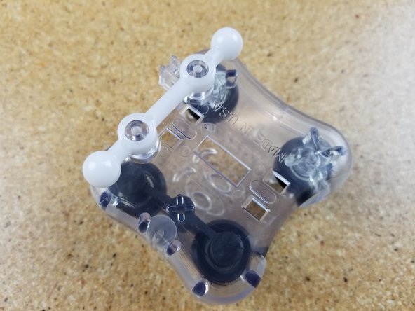 Install the ball joint bars on the mounting pegs as shown.