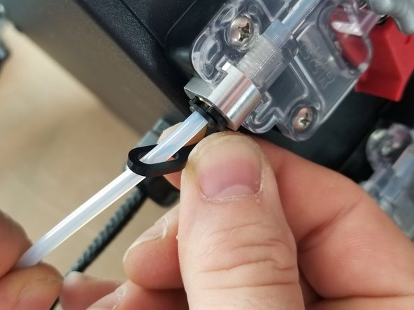 Clip the &quot;C&quot; shaped end of the lanyard into the black ring of the PTC fitting