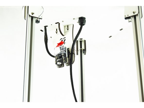 Bring the hotend/arms down to the height of the bed, (nozzle touching) at the location furthest from the extruder. This location is located to the left of the Y axis tower.