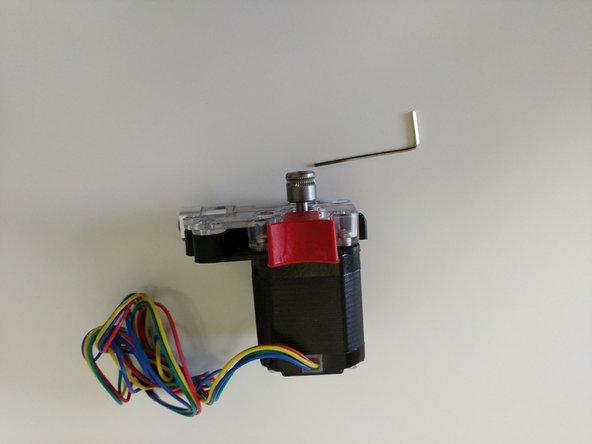 Slide the hobbed drive roller onto the stepper motor shaft. Note the orientation of the hobbed drive roller shown in the second image.