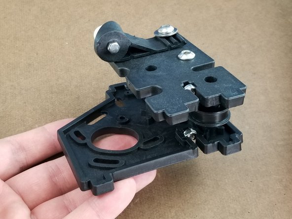 Line the bracket halves shown in Pic 1.  The peg of the large bracket will go into the idler you installed on the smaller bracket.