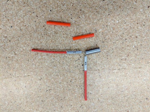 Locate the red silicone tube from the kit.  Cut this tube in half so you have 2 pieces of equal length.