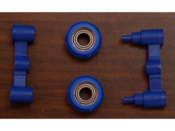 The spring arms consist of an inner and outer halves that retain two of the R4ZZ bearing rollers you assembled in Step #1.