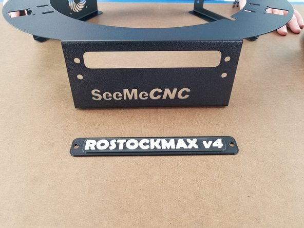 Locate the ROSTOCKMAX v4 nameplate and two nylon push rivets.  Also grab the lower sheet metal cover plate as seen in the pictures.