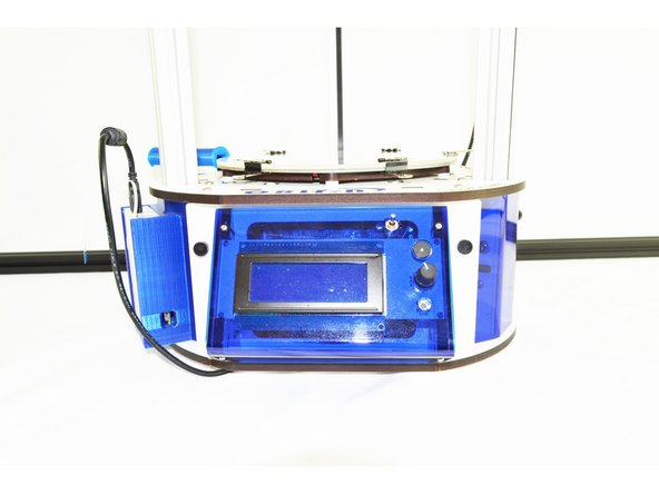 Once you have those tabs starting to engage in the slots, you can push on the bottom of the RAMBo board to get it to seat into the board holder legs on the bottom plate of the base.