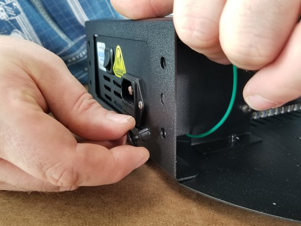 Using 2x nylon push rivets, secure the sheet metal cover to the power supply bracket through the lower holes as shown in Pic 2.