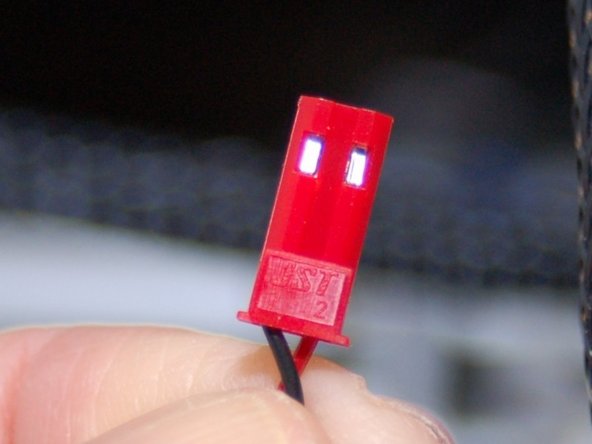 Insert the sockets into the JST housing as shown in the 2nd image.  Remember, the black wire goes into position #1 and the red wire goes into position #2.  They're numbered, but can be hard to see.