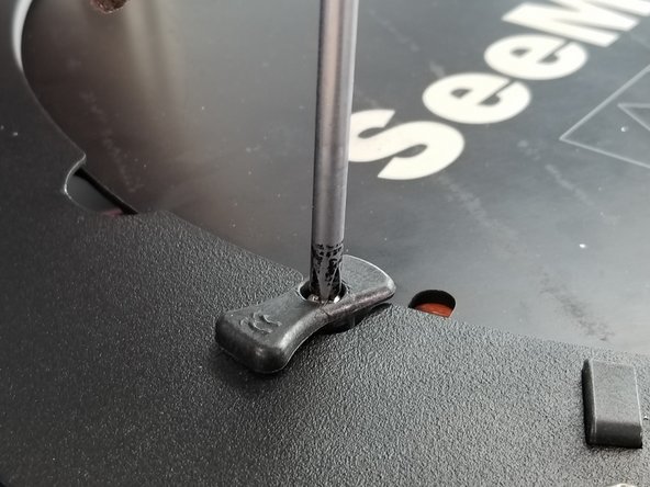 Twist the build plate clamps so they are parallel with the bed opening to allow for glass installation later.