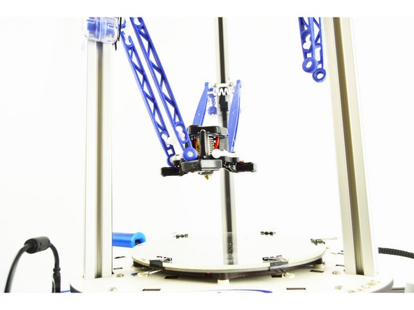 Start with the Z axis tower arms. You are going to connect these arms to the ball joint that are located directly in front of the hotend fan so that when hanging loose as in the image, you can read SeeMeCNC from left to right.
