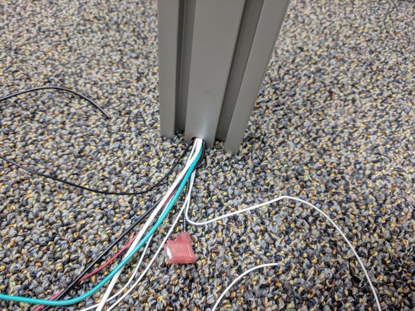 You will now install the Z tower, similarly to how you installed the X tower. The Z tower is the one in which you previously ran wires down. Start by making sure the end-stop legs are folded over.