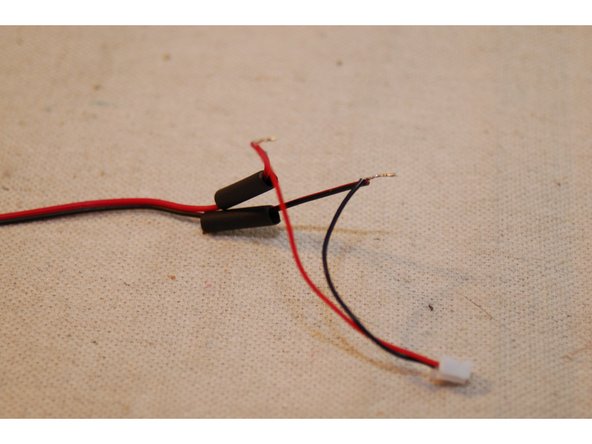 Cut the 30mm heat shrink in half and set it aside. Strip about 6mm from each of the fan and connector wires.