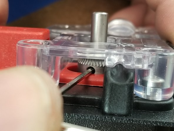 Align the set screw with the access window and slide the hobbed gear down the extruder shaft to the point the middle of the teeth are lined up with the feed hole as shown in Pic 1.