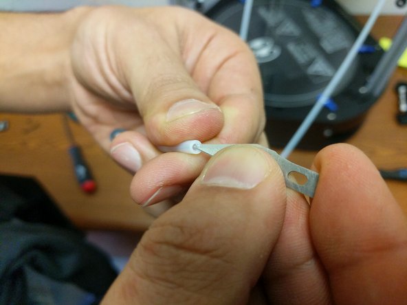 Cut the remaining ptfe tubing in half.  Each of these will be the new bowden tubes running from the EZRstruders down to the dual feed adapter.  Install the bowden tubes into each of the extruders. Be sure to install the supplied lanyard clips. After installation of the lanyard clip, give the bowden tube a final press up into the extruder assembly.