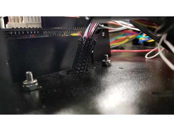 Pass the 6-32 x 1" machine screws through the touch screen arm assembly and the holes next to the Duet board as shown, and secure the screen assembly in place with the 6-32 nylon lock nuts.