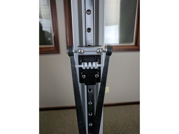 Next install the arms to the ball joints. Press the arms onto the ball joints until you hear it pop/click. It is easiest to install both arms to the carriage and then insert the tension spring between the arms. Complete all 3 carriages before moving on. Let the arms dangle.