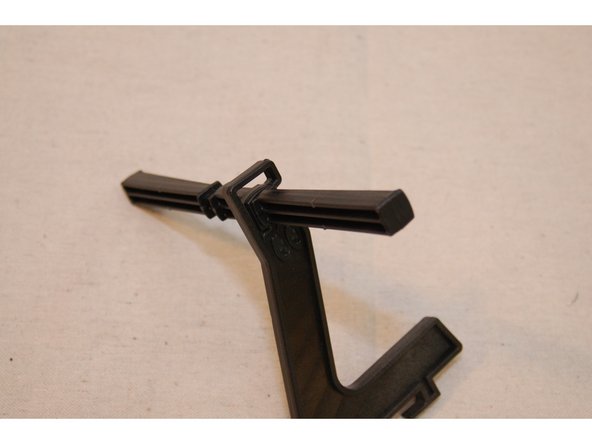 Insert the spool support into the slot in the spool support bar and then rotate the support 90 degrees on the bar.  This should result in the angled face of the bar being oriented &quot;up&quot;.