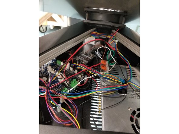 Plug the top cover fan connector back in to place and reinstall the top cover with the push rivets you removed in the beginning steps.