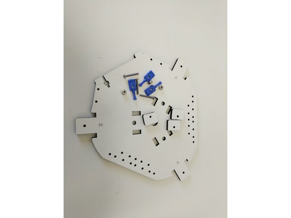 Locate the (3) 6-32 x 1&quot; screws, (3) 6-32 nylon lock nuts, (3) blue build plate clamps, &amp; (3) laser cut build plate spacers.