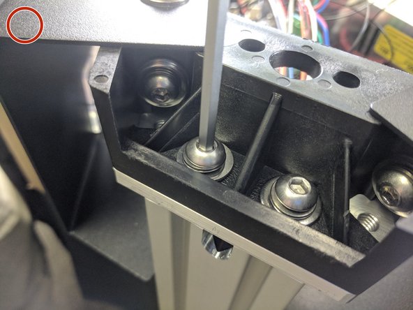 Attach the tower to the upper assembly using 2 each of the provided 1/4-20 x 1" long button head screws, split ring washer, and flat washer, stacked as shown in the image with the blue circle. Fully Tighten.