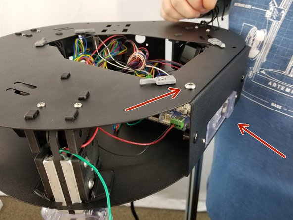 Working on the duet side of the upper frame as shown in Pic 2, you will insert the button head screw through the hole pointed out with the arrow in Pic 2, from the under side you will insert the spike washer with the spikes facing the sheet metal, followed by the ring terminal from the green wire installed earlier, followed by the lock nut.
