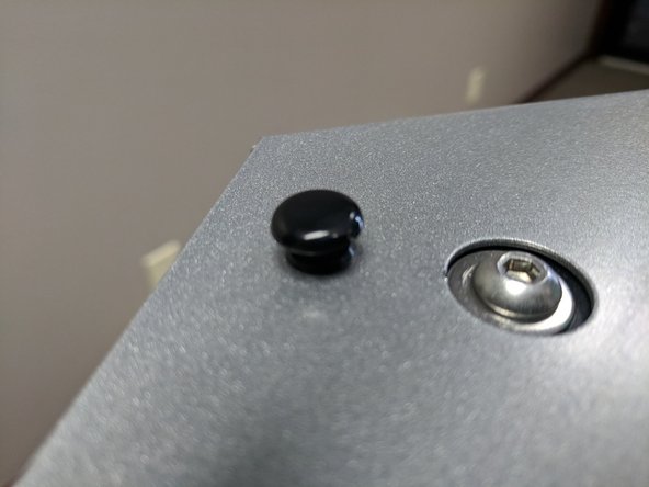 You will now re-install the base cover. Before doing so, make sure all wires are secured and not going to interfere with its installation. If you find a loose wire, use a zip tie to secure it to a piece of T-Slot.