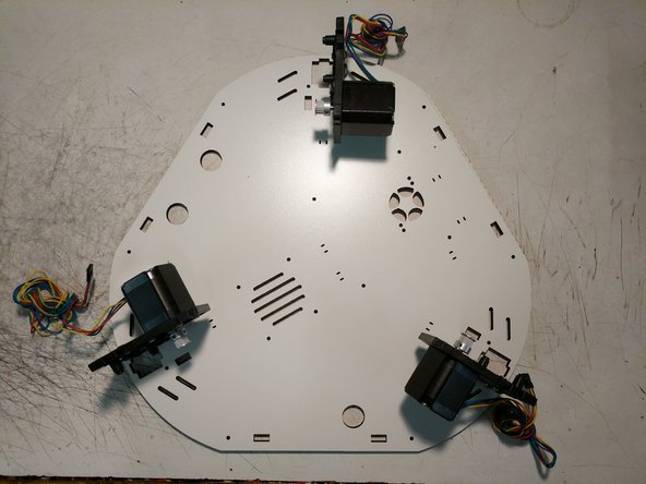 Install the (3) motor mounts on the Top Base Plate using (1) 6-32 x 1&quot; screw per motor mount. Do not fully tighten these screws.  Note the orientation of the Top Base Plate. There is laser engraved text on this plate noting which side should be DOWN)