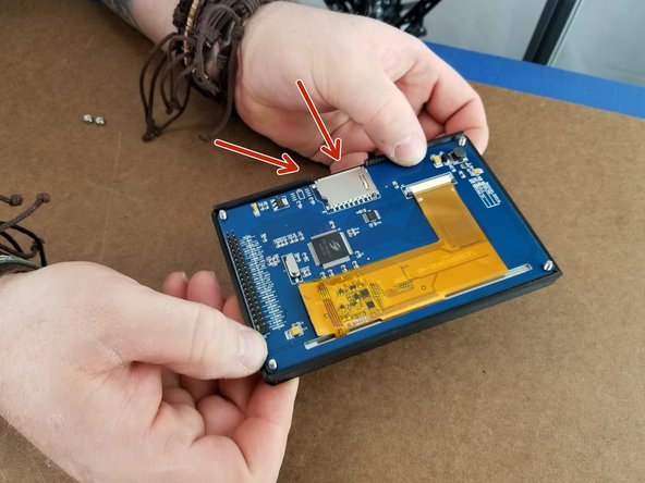 Pass the screws through the holes in the touch screen control board.