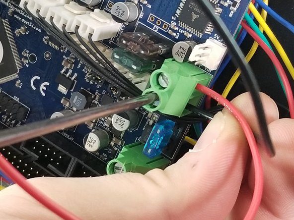 The red wire will be inserted (make sure the wire is stripped) into the position furthest from the blue fuse as shown in Pic 2.