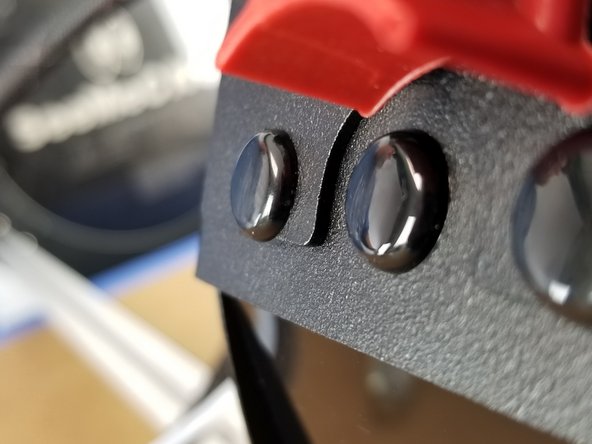Re-install the plastic rivets by placing them in the mounting holes in the sheet metal, pushing the bottom portion in fully, then pushing the head until the rivet snaps in place flush with the sheet metal.